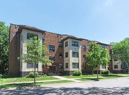 a large brick building with trees in front of it