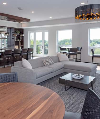 a living room filled with furniture and a large window