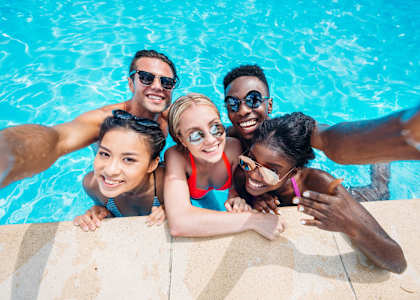 a group of people in a swimming pool at The Arbor Walk Apartments, Tampa, Florida