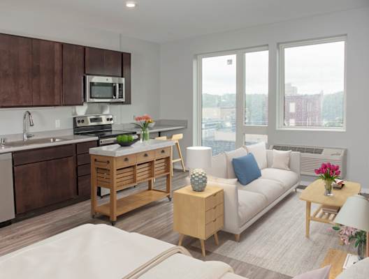a living room with a couch a table and a microwave