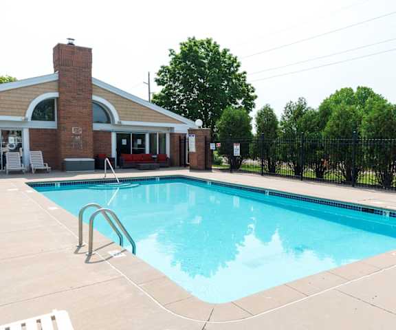 a swimming pool with a building in the background