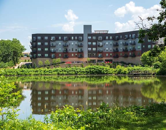 a large building with a lake in front of it
