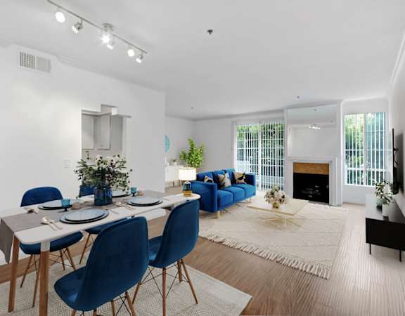 a living room with a dining room table and a fireplace