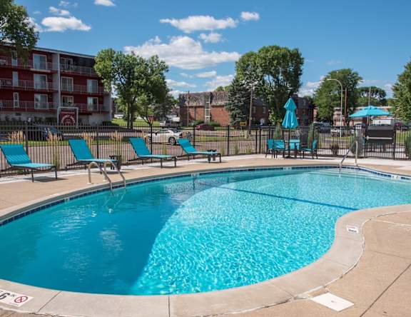 outdoor pool with sundeck and lounge chairs