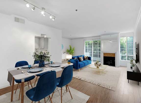 a living room with a dining room table and a fireplace