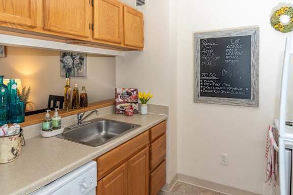 A kitchen with a chalkboard on the wall.