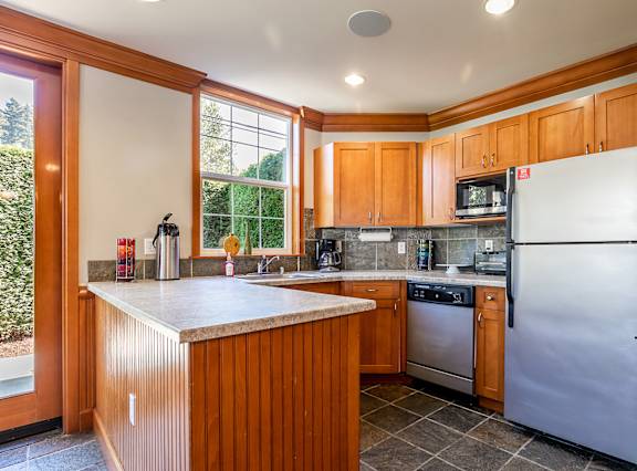 Kitchen with stainless steel appliances - Springbrook Apartments