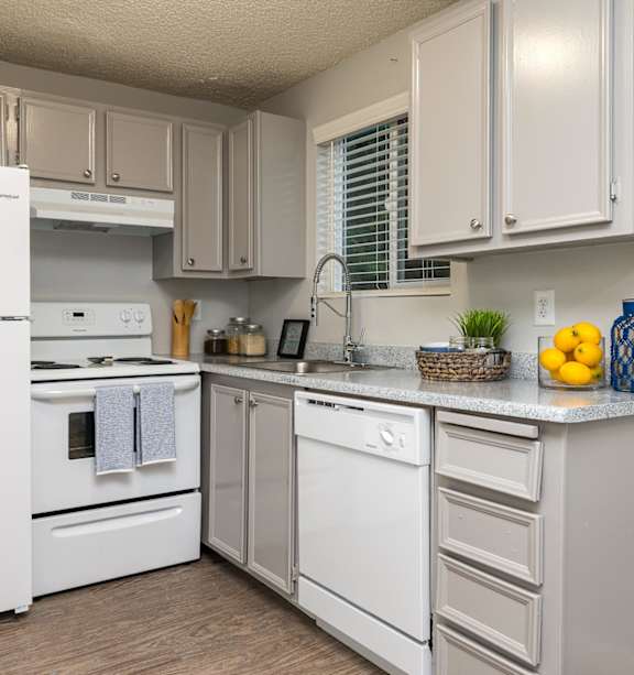 A kitchen with white appliances and cabinets.