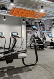 a spacious workout room with treadmills and other exercise equipment