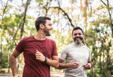 two men running together in the park at Ardor on the Bluffs South Loop Residences Apartments, Bloomington, 55425