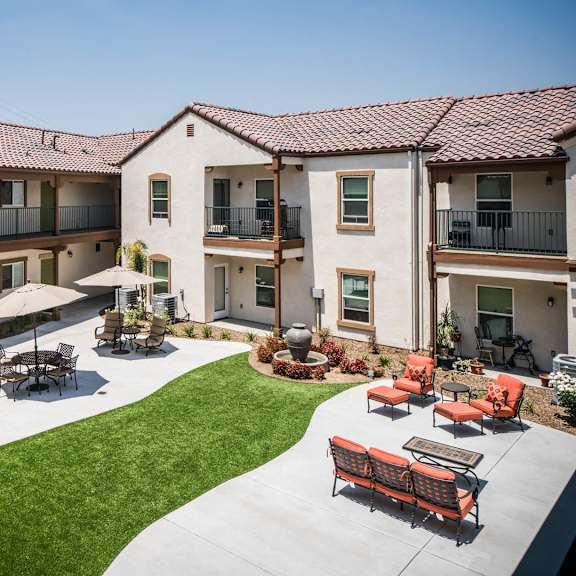 The front of the Mesa Vista Apartments building with a flag flying in the background.