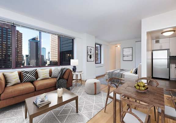 A modern living room with a brown sofa and a wooden coffee table at The Ellington Apartments, New York, NY, 10019