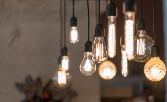 a row of light bulbs hanging from a ceiling at The Edison at Blue Springs, Blue Springs, 64014