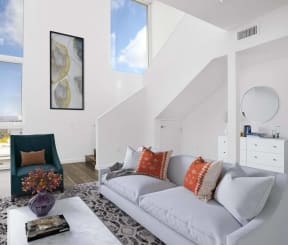a living room with a white couch and a chair at The Lucky Apartments, Culver City, 90066