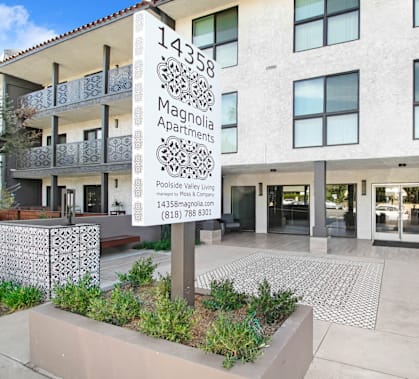 the front of a building with a sign in front of it