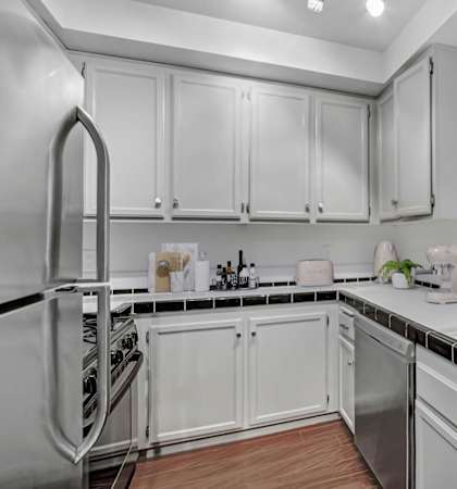the preserve at ballantyne commons apartment kitchen with white cabinets and stainless steel appliances