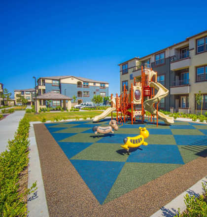 a playground at the flats at big tex apartments in san antonio, tx