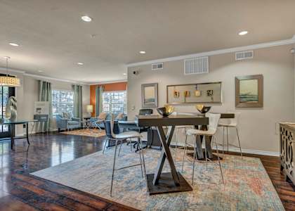 A dining room with a table and chairs.