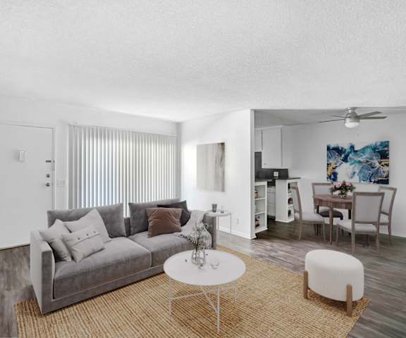 the living room of an apartment with a couch and a table