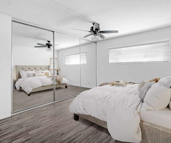a bedroom with a large mirror and a bed