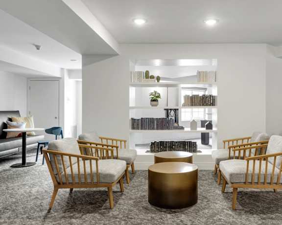 a living room with chairs and a table