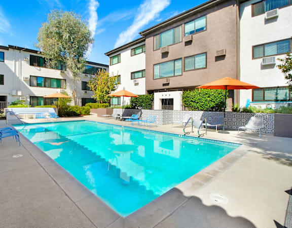 our apartments have a pool and lounge areas with umbrellas