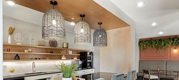 a kitchen and dining room with blue chairs and a table