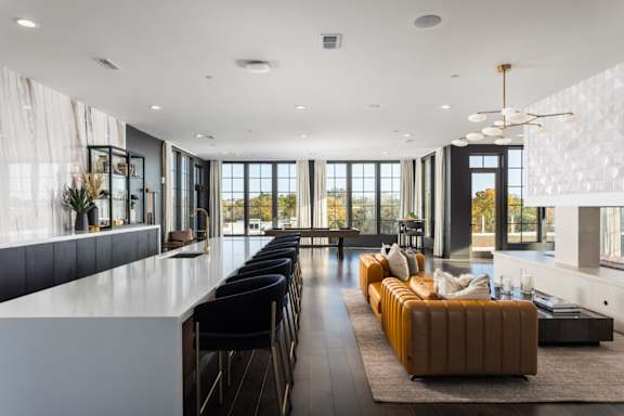 A modern kitchen with a dining table and chairs.