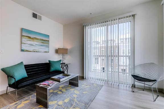 a living room with a couch and a coffee table at East 51 At Rocketts Landing, Richmond, 23231
