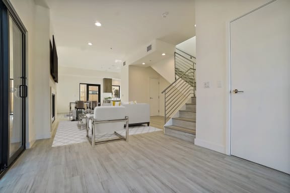 a living room with a couch and a table and a staircase
