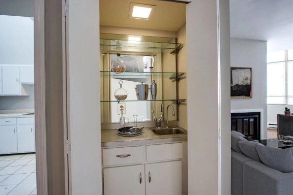 a small kitchen with a sink and a mirror  at Metro67, Memphis, TN, 38103