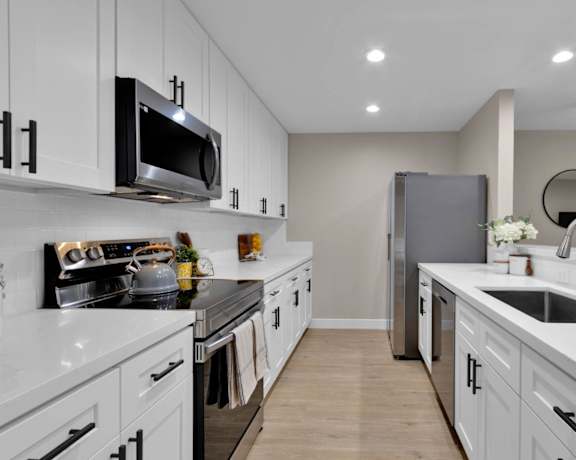 kitchen in a bedroom plus den unit.
