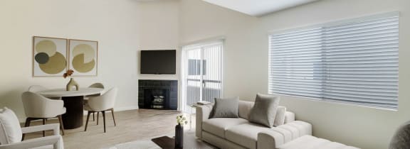 a living room with a couch and a table and a fireplace