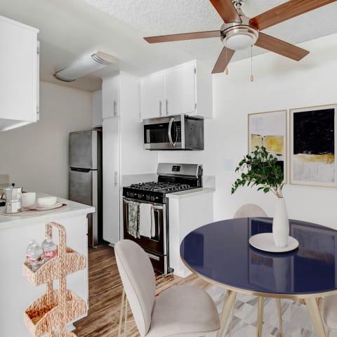 a kitchen with stainless steel appliances and white cabinets