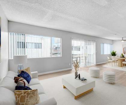 a living room with a white couch and a dining room table
