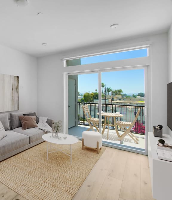 a living room with a couch and a table and a balcony