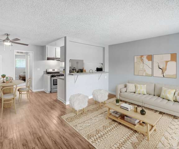 the living room and dining room of an apartment