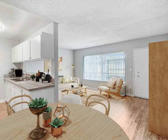 a living room with a dining room table and a kitchen