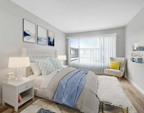 a bedroom with a large bed and a window
