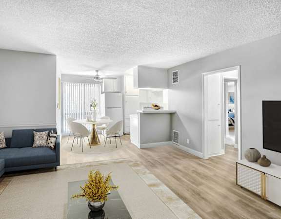 a living room and kitchen with a couch and a table