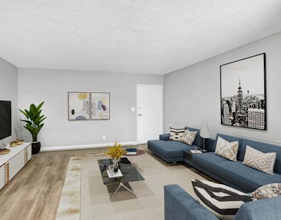 a living room with blue couches and a tv