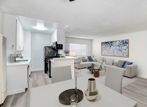 an open living room and kitchen with a white table