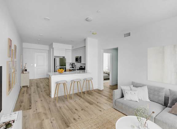 a living area with a kitchen and a couch