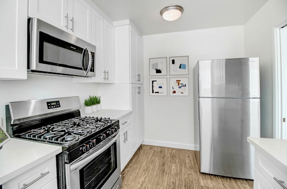 a kitchen with stainless steel appliances and a refrigerator