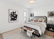 Thumbnail 7 of 51 - A bedroom with a large bed and a painting on the wall.