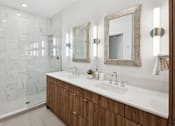 Thumbnail 4 of 51 - A bathroom with a white sink and a mirror above it.