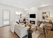 Thumbnail 15 of 51 - A modern living room with a fireplace and a grey couch.