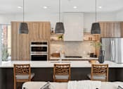 Thumbnail 12 of 51 - A modern kitchen with wooden cabinets and a white island.