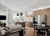 Thumbnail 28 of 51 - A modern kitchen with a dining table and chairs.
