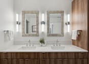 Thumbnail 23 of 51 - A bathroom with two sinks and two mirrors.